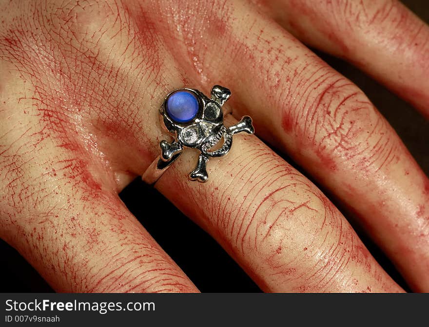 Photo of a Bloody Hand With a Skeleton Ring - Halloween Decoration