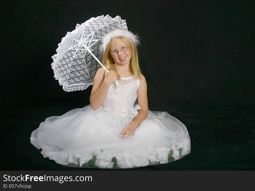 Girl sitting in a pretty dress holding a lace umbrella. Girl sitting in a pretty dress holding a lace umbrella