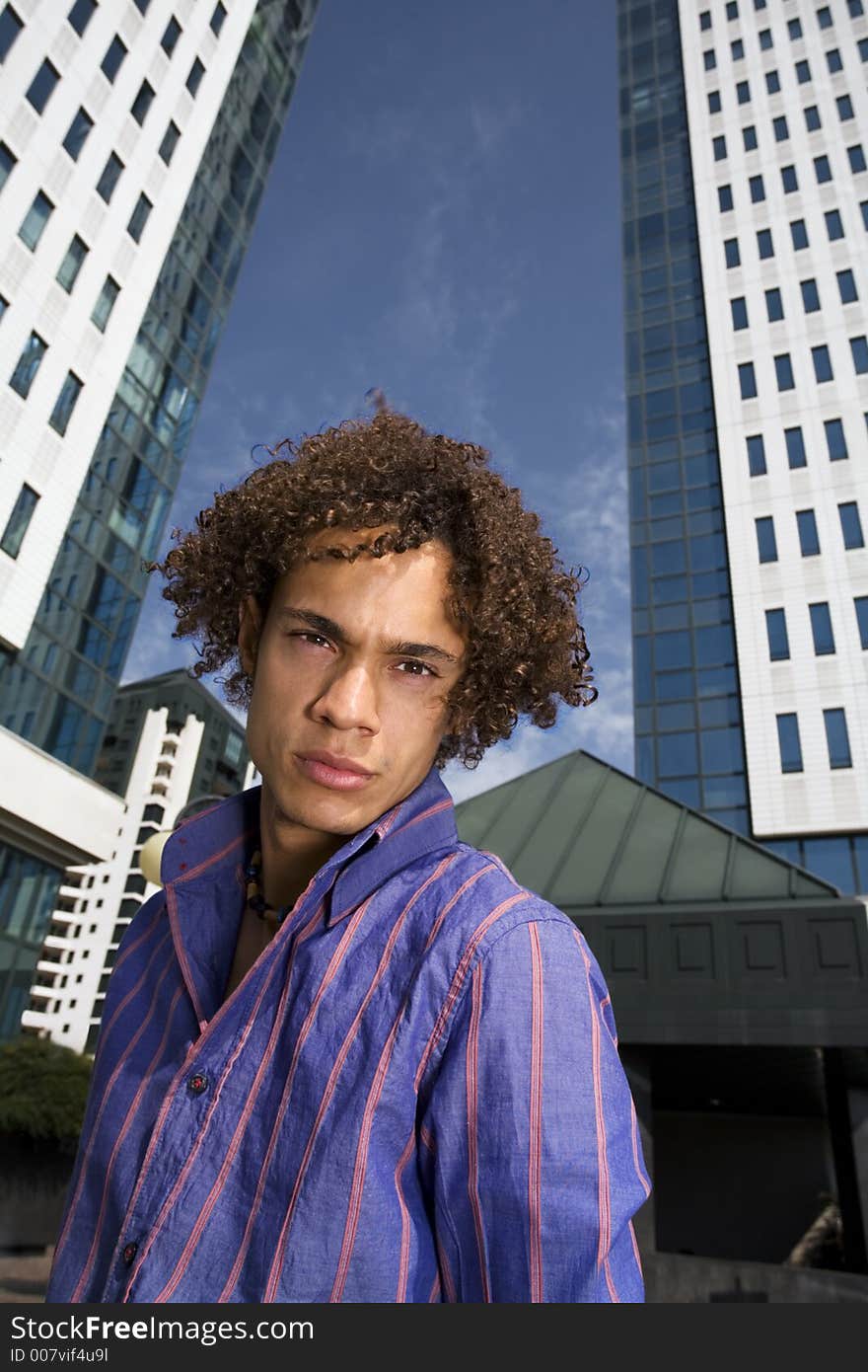 Young businessman in front of a building. Young businessman in front of a building