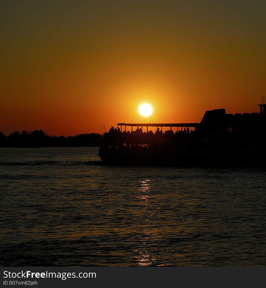 A wonderful sun down in the Venetian lagoon, with a passenger boat sailing by. Nice place to be!. A wonderful sun down in the Venetian lagoon, with a passenger boat sailing by. Nice place to be!