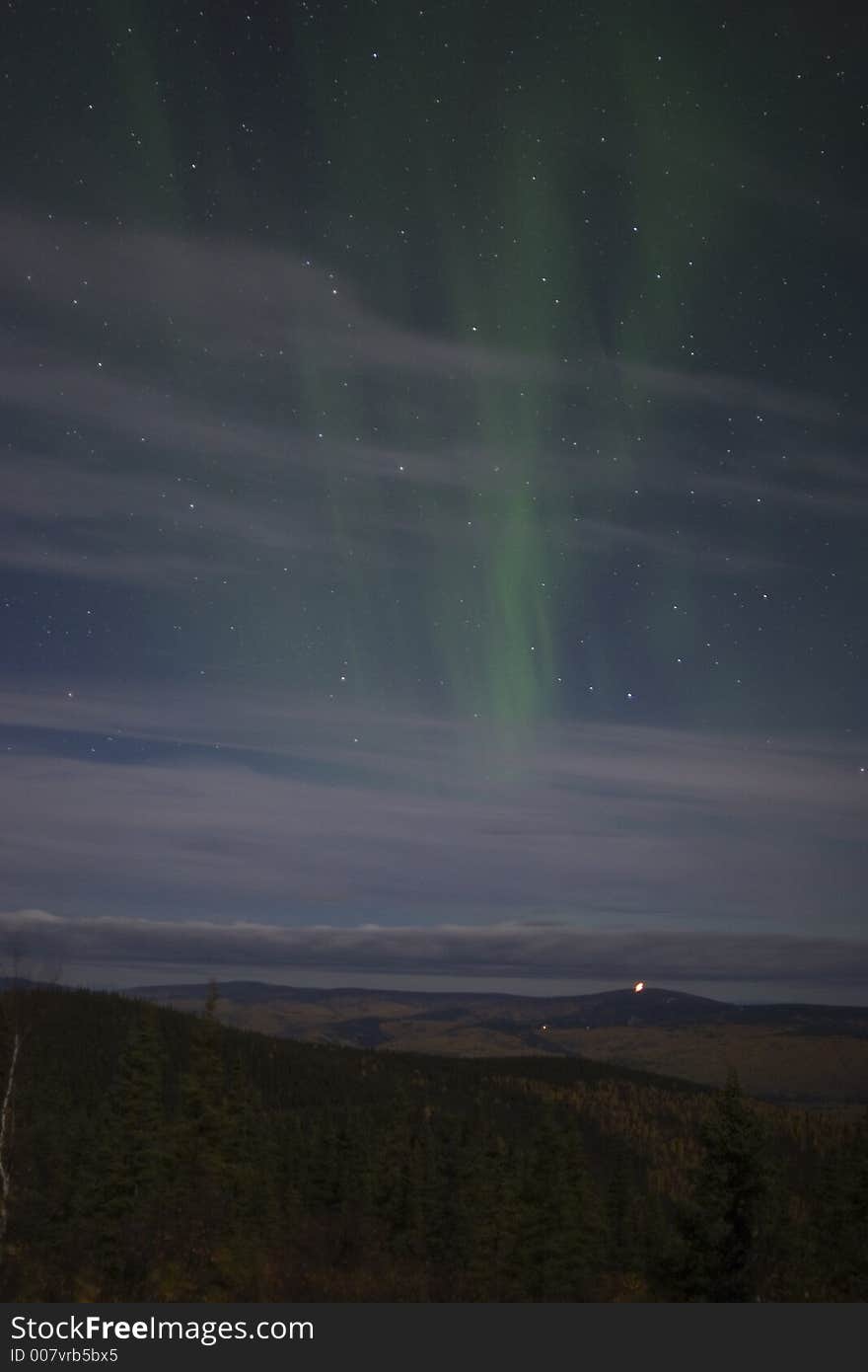 Beraly visible northern lights in cloudy sky. Beraly visible northern lights in cloudy sky