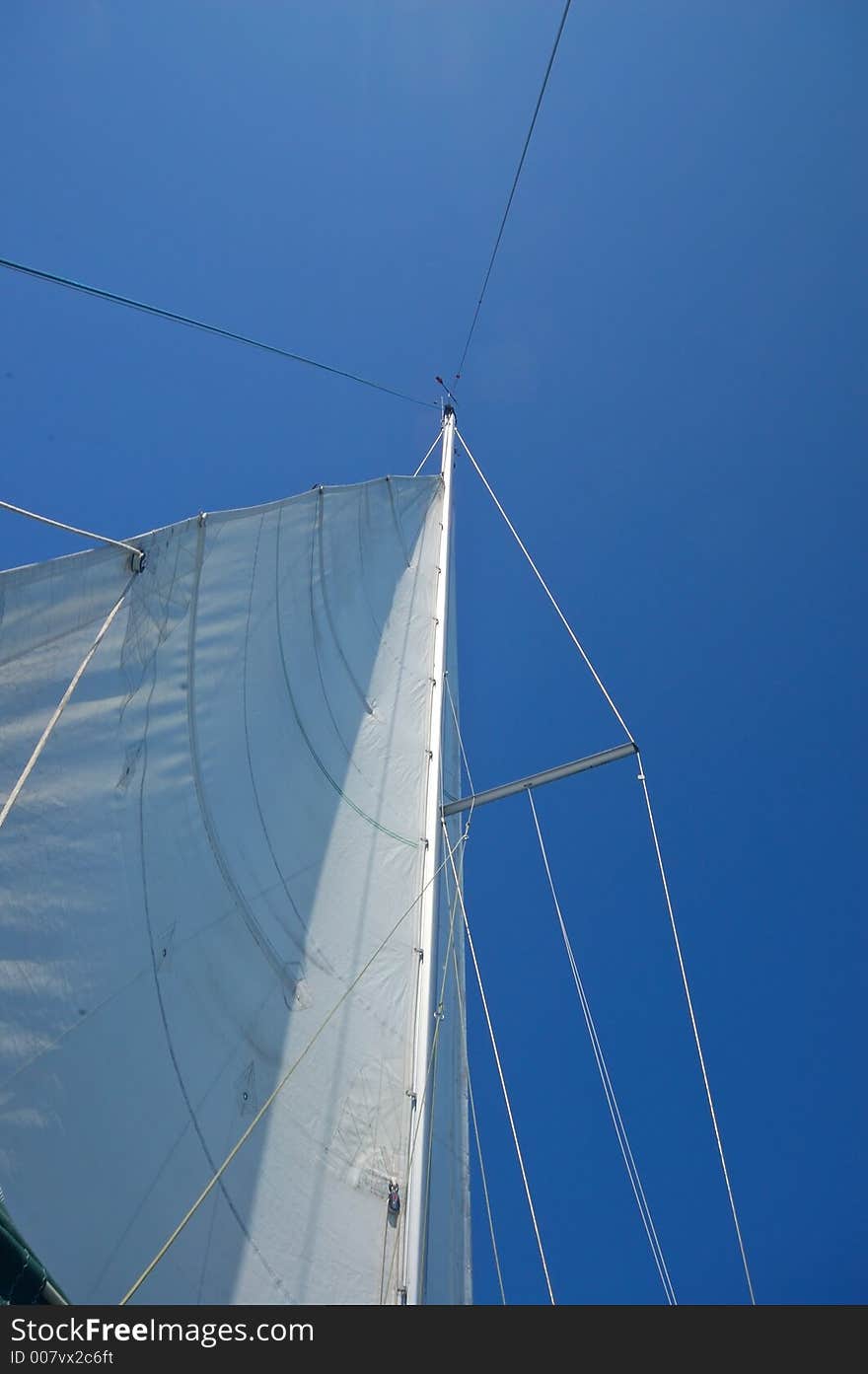 The mast of a sailboat. The mast of a sailboat