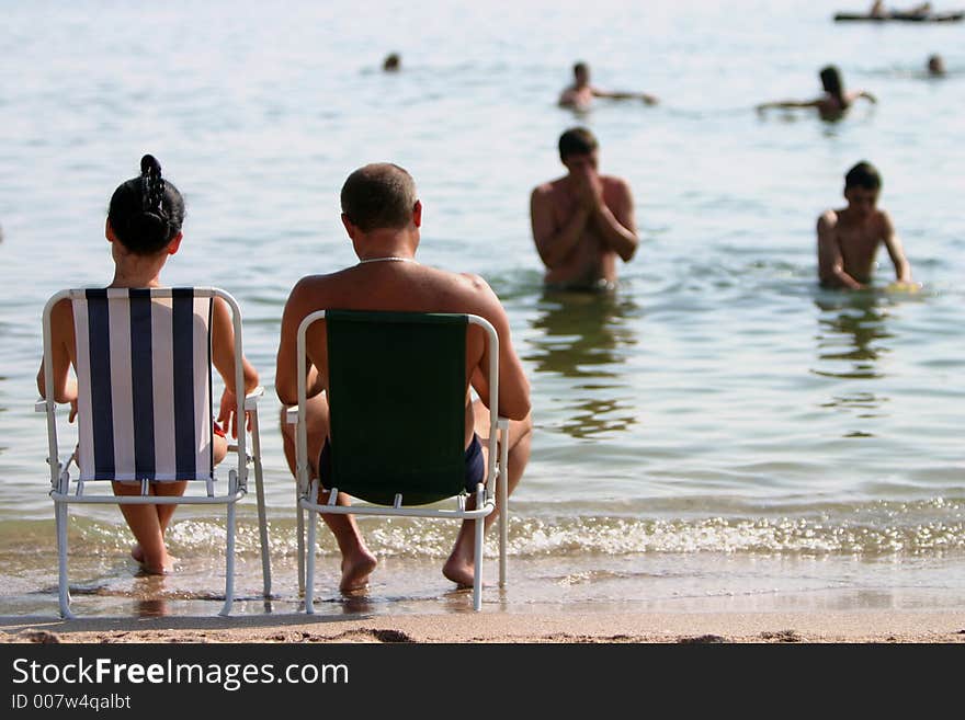 Couple in vacation relaxing on the wrm summer sun. Couple in vacation relaxing on the wrm summer sun