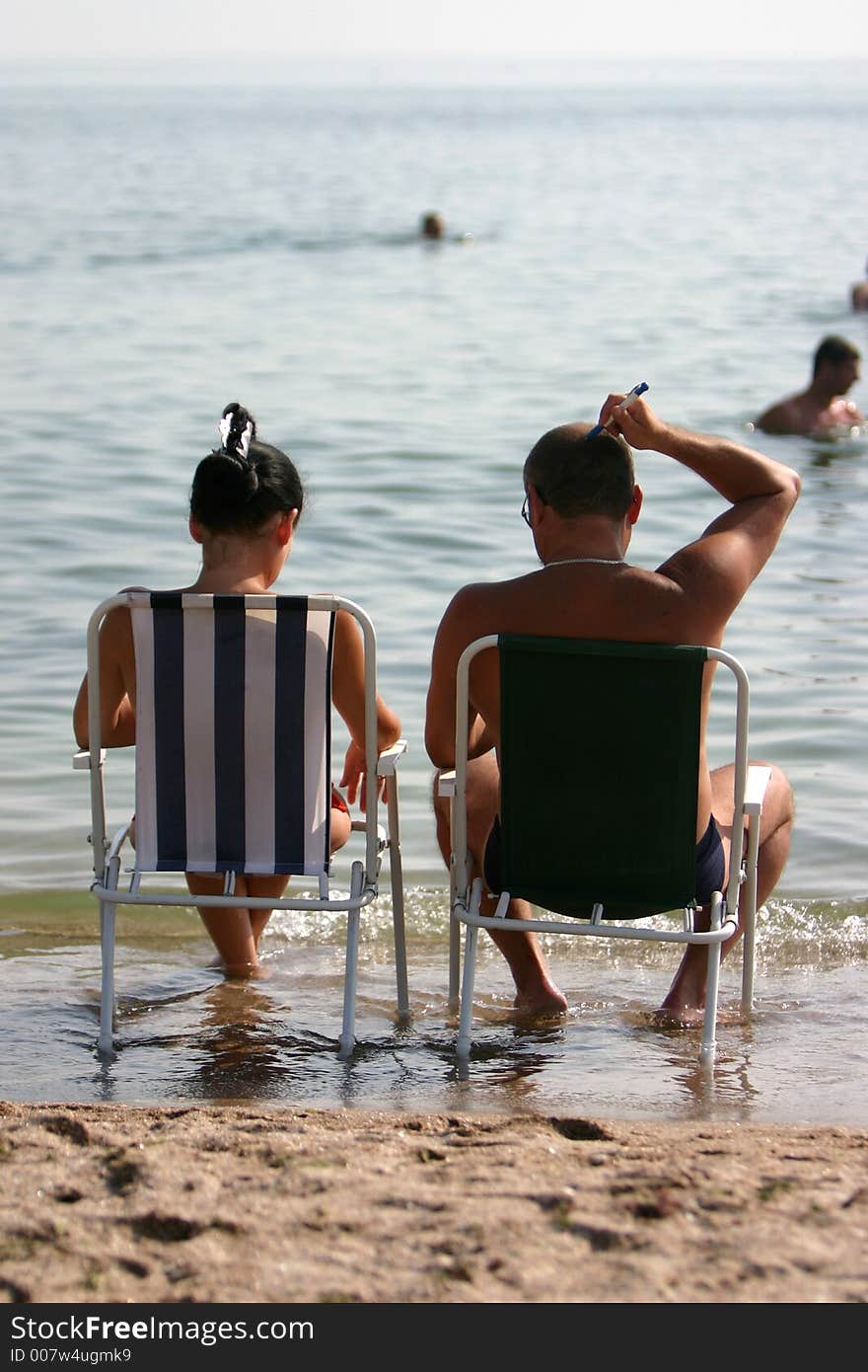 Couple near sea shore relaxing on the summer hollyday. Couple near sea shore relaxing on the summer hollyday