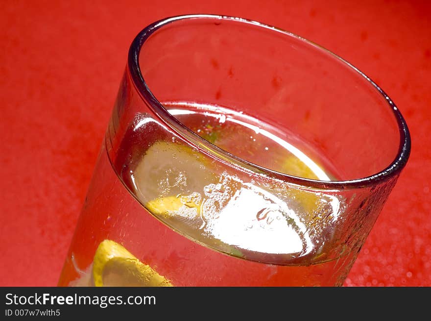 Close up of glass with drink and lemon. Close up of glass with drink and lemon