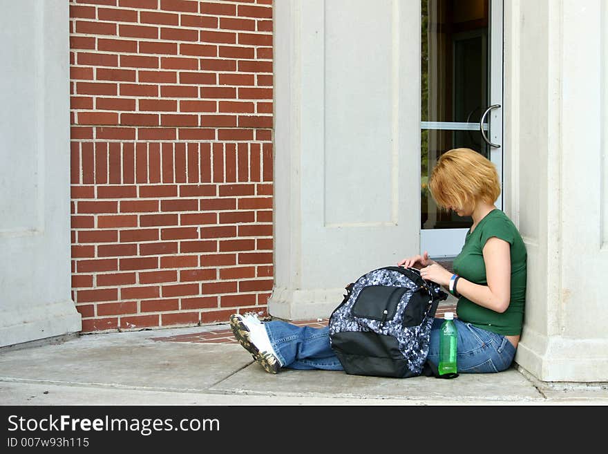 Teen girl sitting on porch with bag. Teen girl sitting on porch with bag