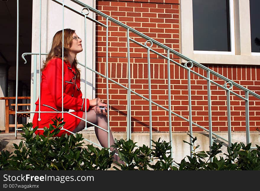 Businesswoman sitting on stairs with cell phone. Businesswoman sitting on stairs with cell phone