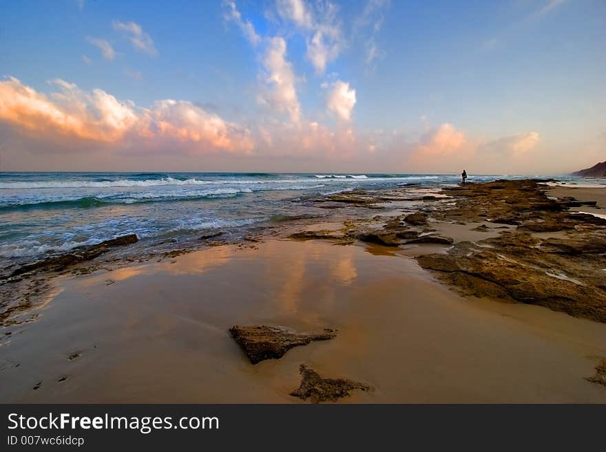 A man standing on a sea shore. A man standing on a sea shore