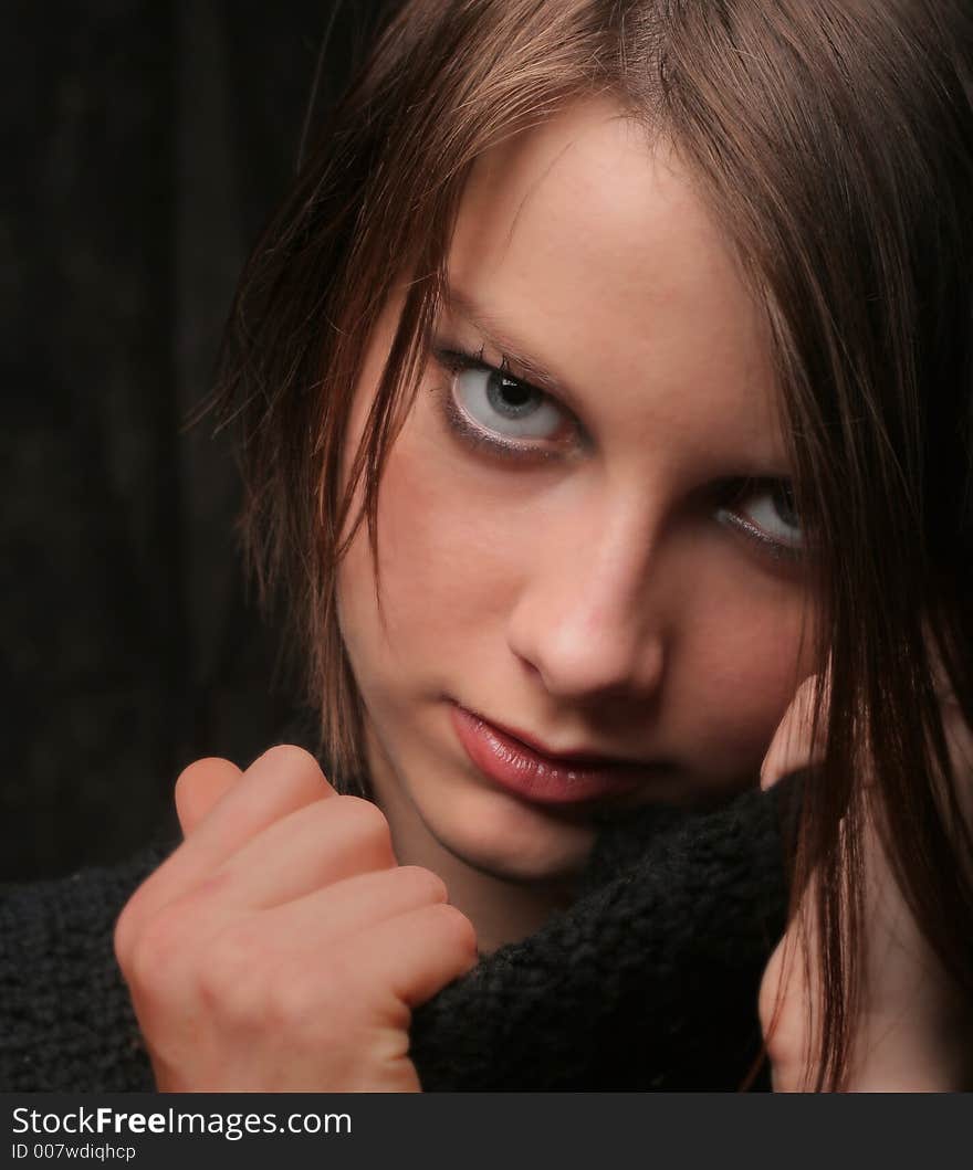 Woman with short hair and blue eyes against soft green background. Woman with short hair and blue eyes against soft green background