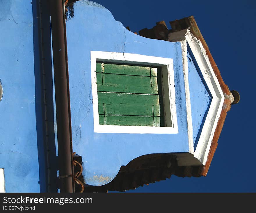 A window on a roof in Burano, Italy. A window on a roof in Burano, Italy