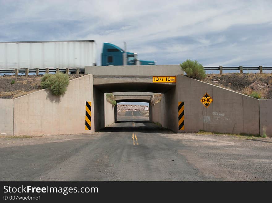 Truck crossing the bridge on a two lane road. Truck crossing the bridge on a two lane road