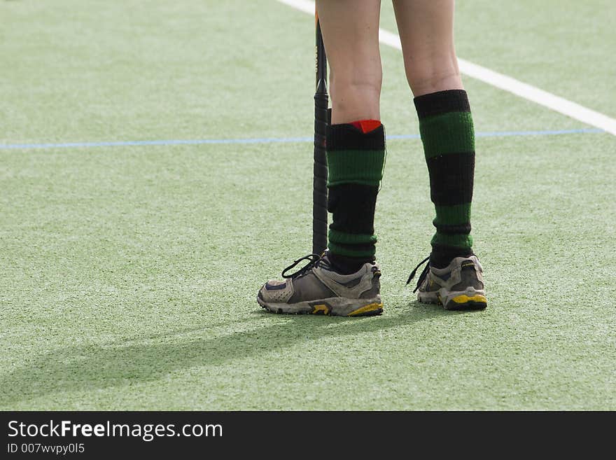 Kid standing on artificial turf playing hockey. Kid standing on artificial turf playing hockey