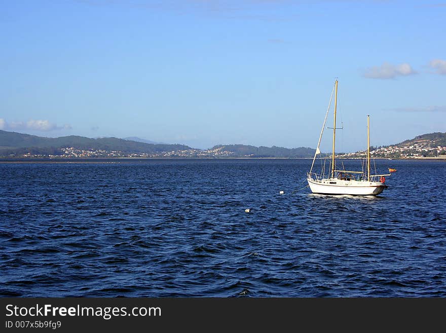 A white fishing boat by the sea.