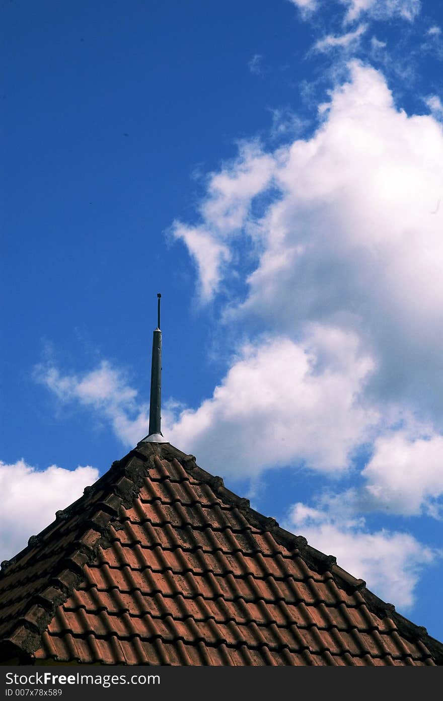 Old roof and tiles and white clouds on blue sky. Old roof and tiles and white clouds on blue sky