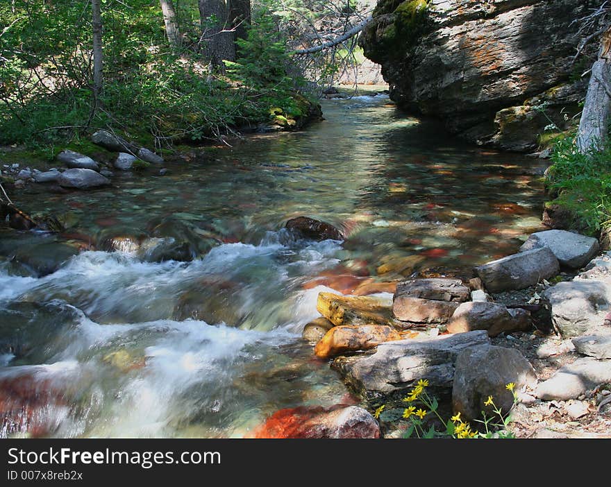 Colorful rocks in mountain stream in Glacier National Park. Colorful rocks in mountain stream in Glacier National Park