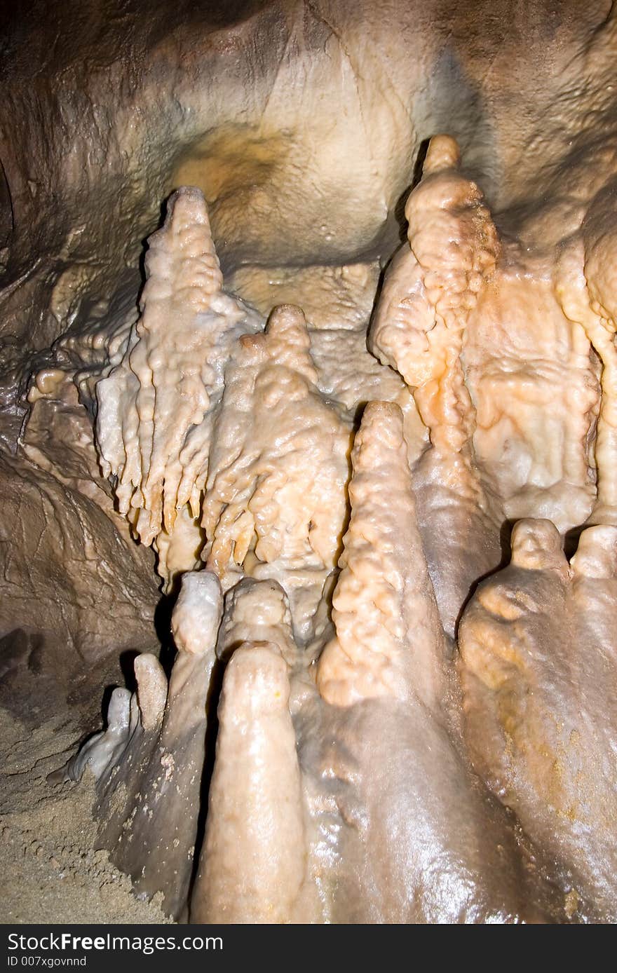 Stalactites on the side of cave wall.