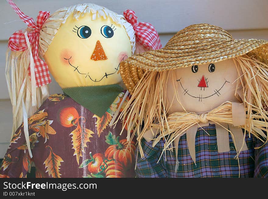 Boy and girl scarecrow with red bows and straw hat. Boy and girl scarecrow with red bows and straw hat.