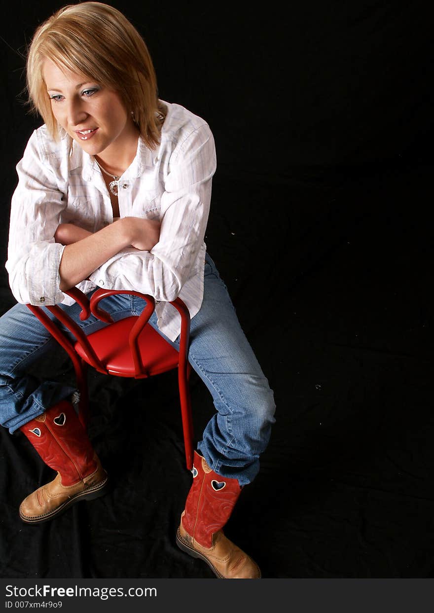 Cute cowgirl posed on black background. Cute cowgirl posed on black background