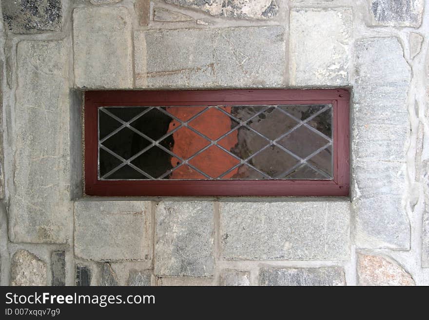 Stained window and stone wall