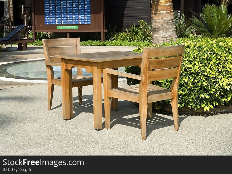 Wooden Table and Chair by the Pool