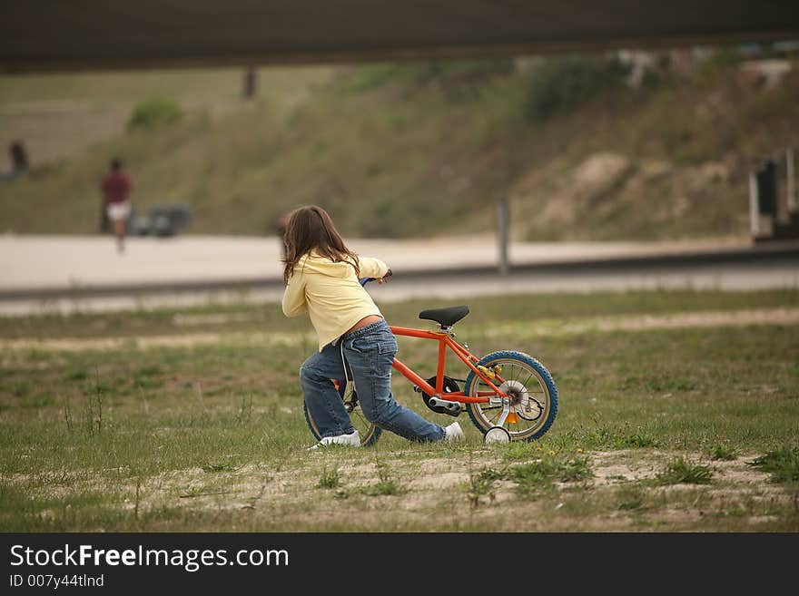 Girl push a bicycle