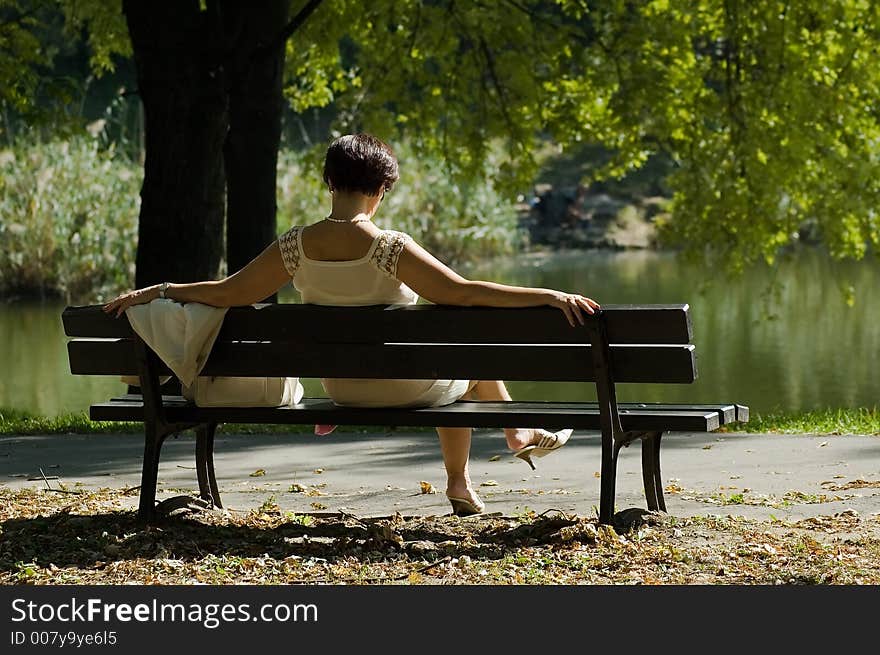 Woman sitiing in a park. Woman sitiing in a park