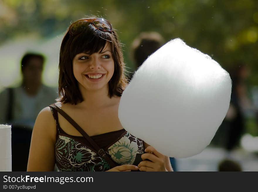 Girl with cotton-candy in a park