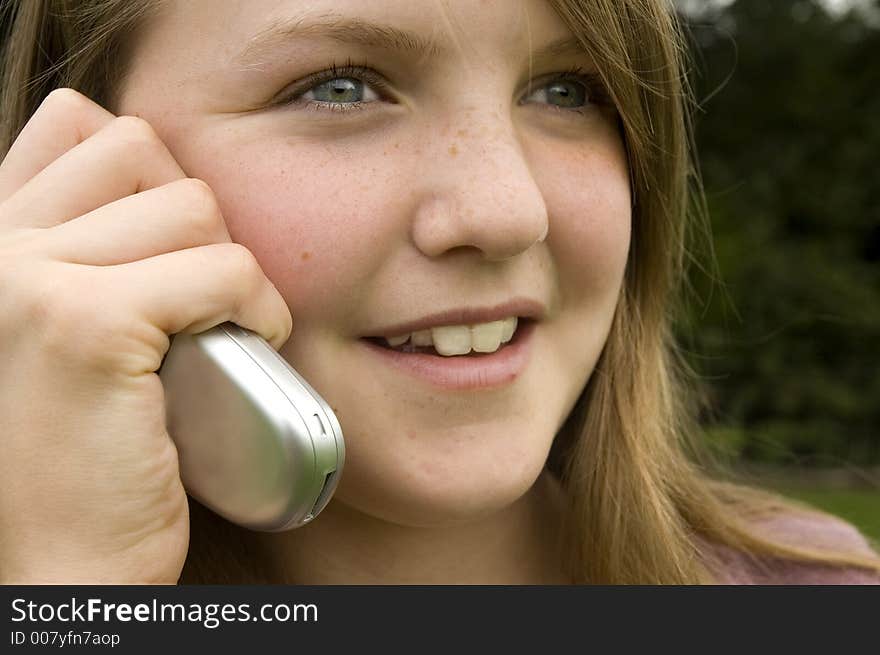 Teenage girl using cellphone outdoors