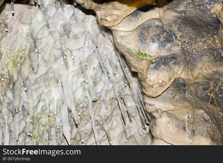 Stalagmites hanging from a cave roof.