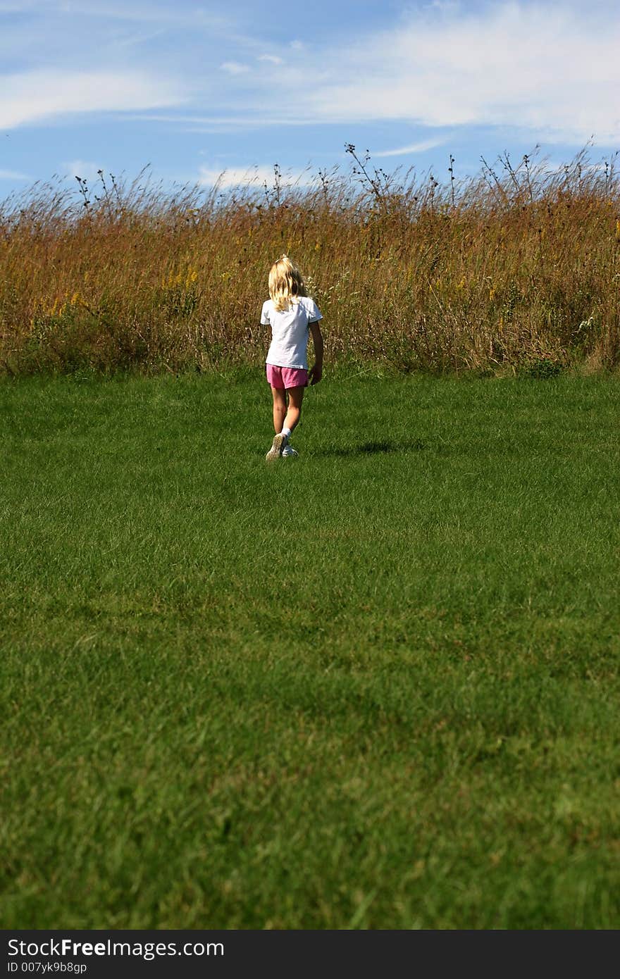 Girl walking in a prairie