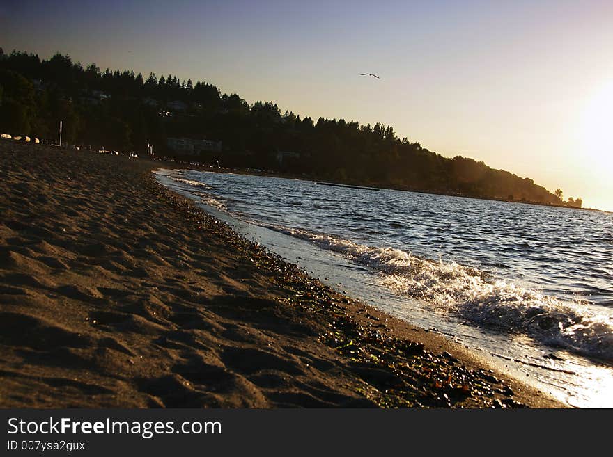 Beach with sun starting to set, golden tinge. Beach with sun starting to set, golden tinge.