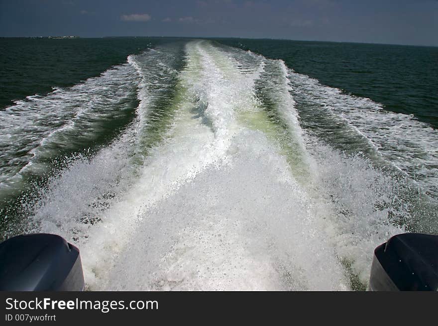 The wake of a speedboat and the north end of Captiva Island. The wake of a speedboat and the north end of Captiva Island