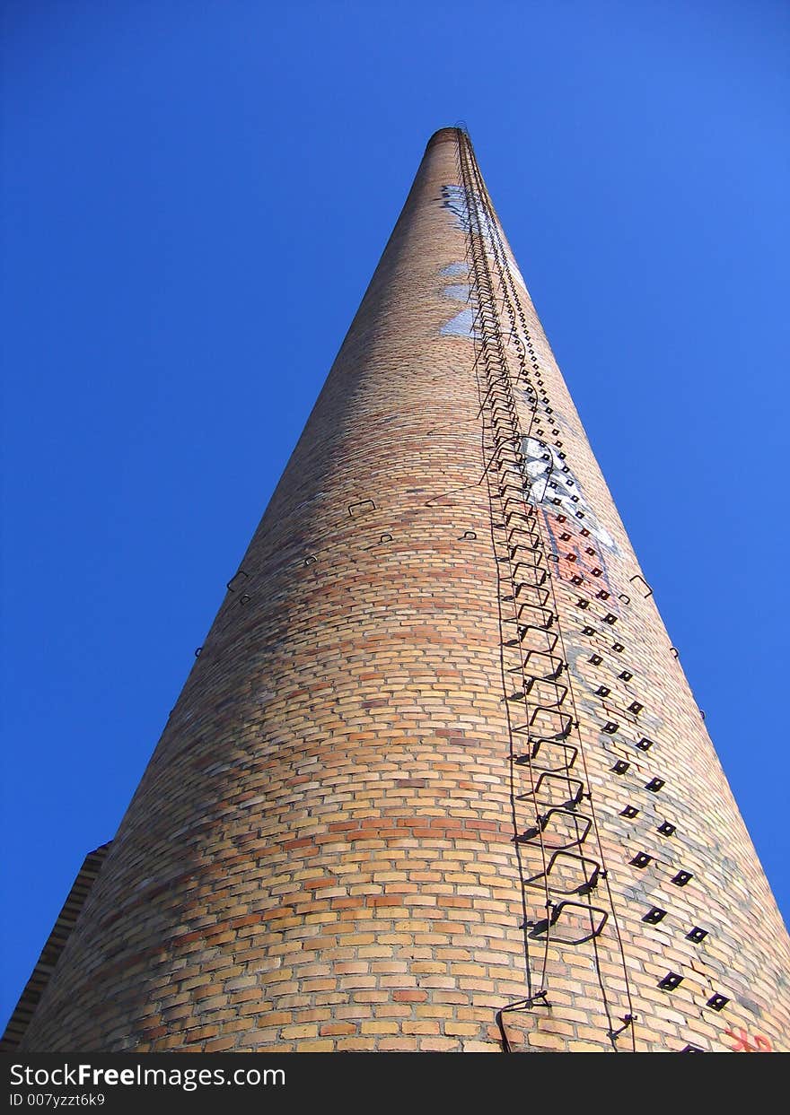 A closed down industrial chimney, decorate with some graffiti. A closed down industrial chimney, decorate with some graffiti.