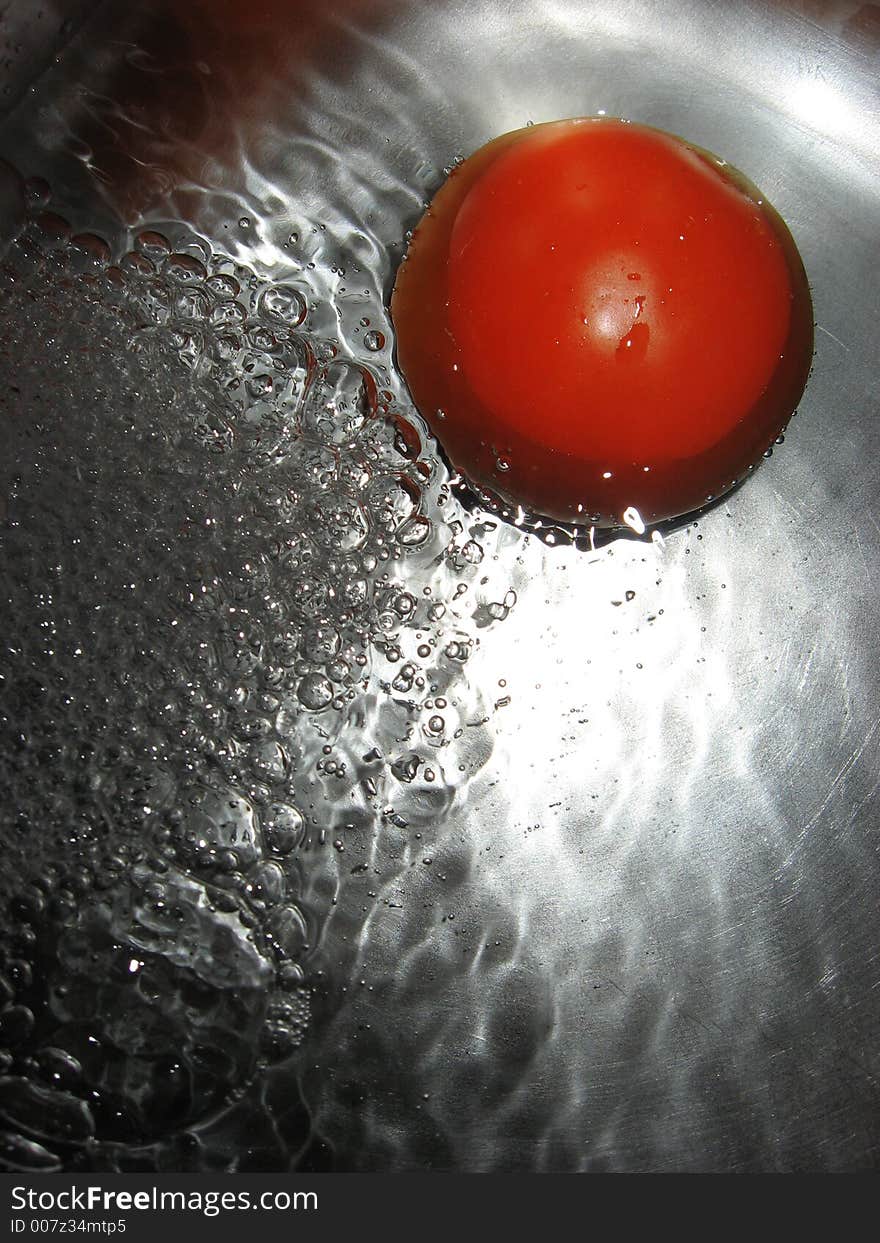 Tomato in water, close up. Tomato in water, close up