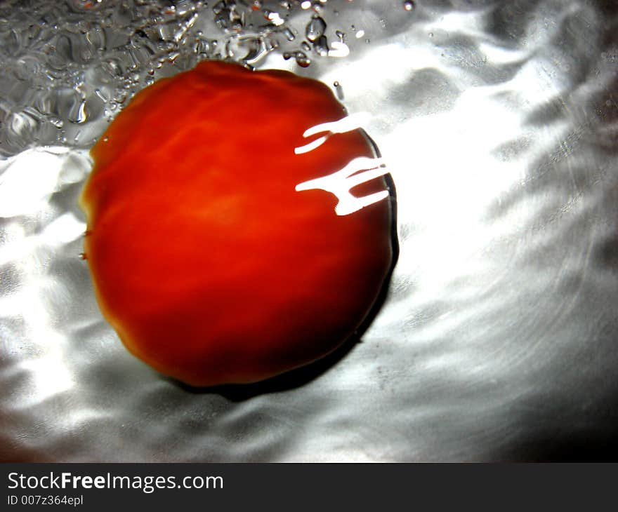 Tomato in water, close up. Tomato in water, close up