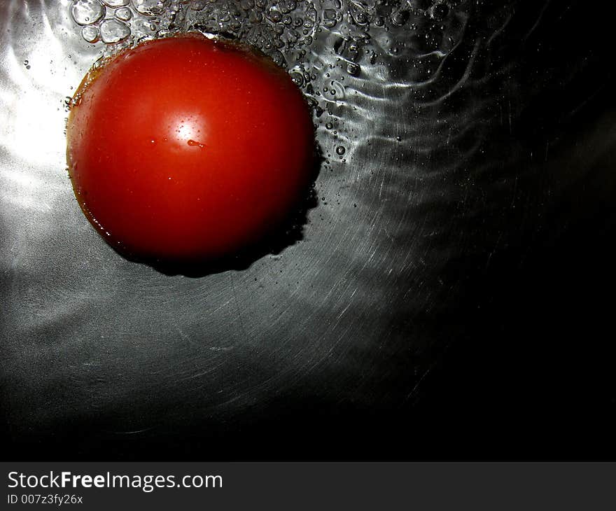 Tomato in water, close up. Tomato in water, close up