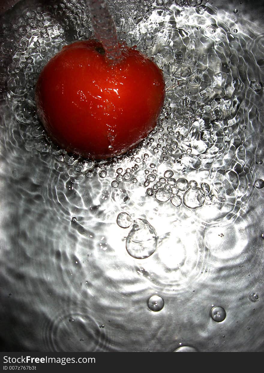 Tomato in water, close up. Tomato in water, close up