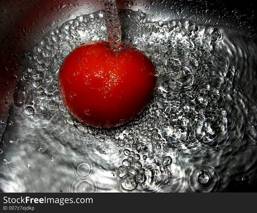 Tomato in water, close up. Tomato in water, close up