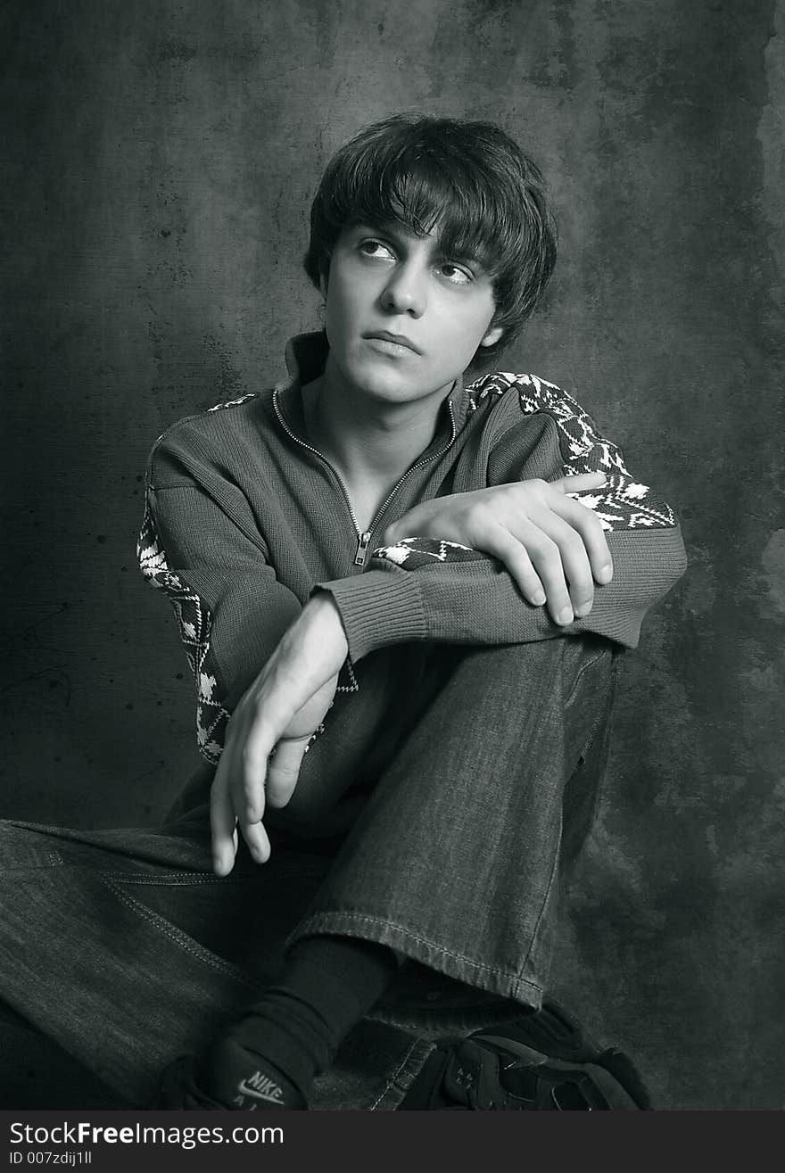 Portrait of the young man, hand in a lap. b/w. Portrait of the young man, hand in a lap. b/w