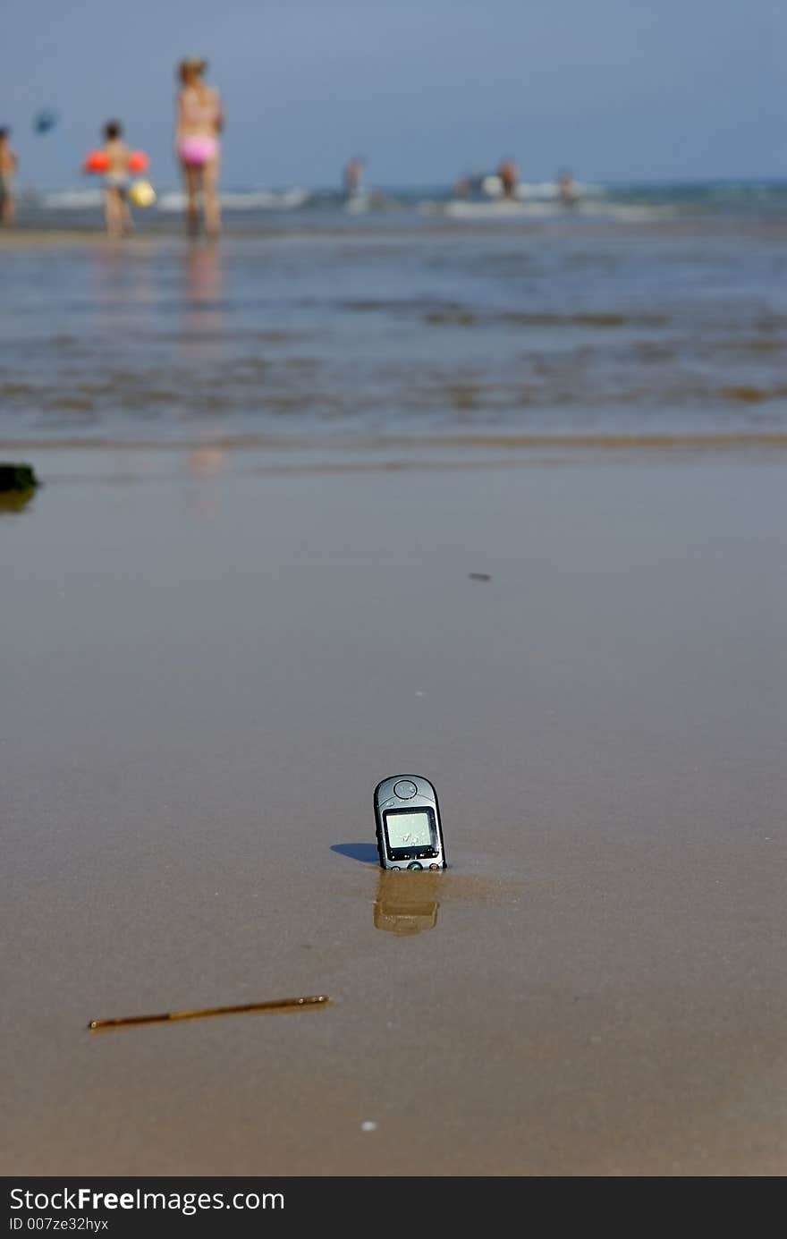 A Cell-Phone left on the beach. A Cell-Phone left on the beach