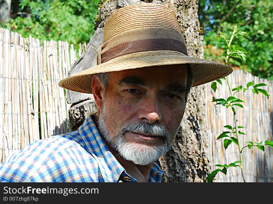 Bearded senior with a straw hat