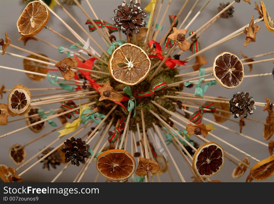 Christmasball made of citrus fruits and pine cones