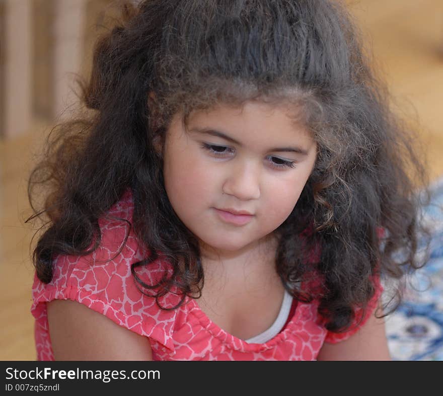 The little girl looking at the floor. The little girl looking at the floor