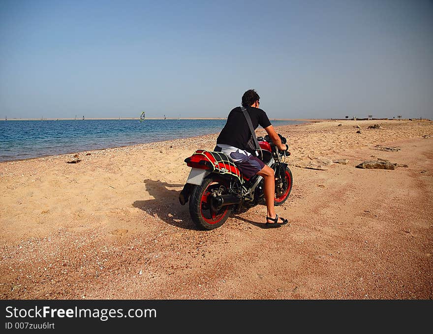 Man driving away with his motorcycle. Man driving away with his motorcycle