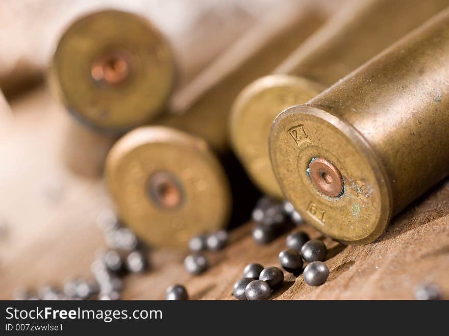 Shotgun shells and shot on wood background. Shotgun shells and shot on wood background