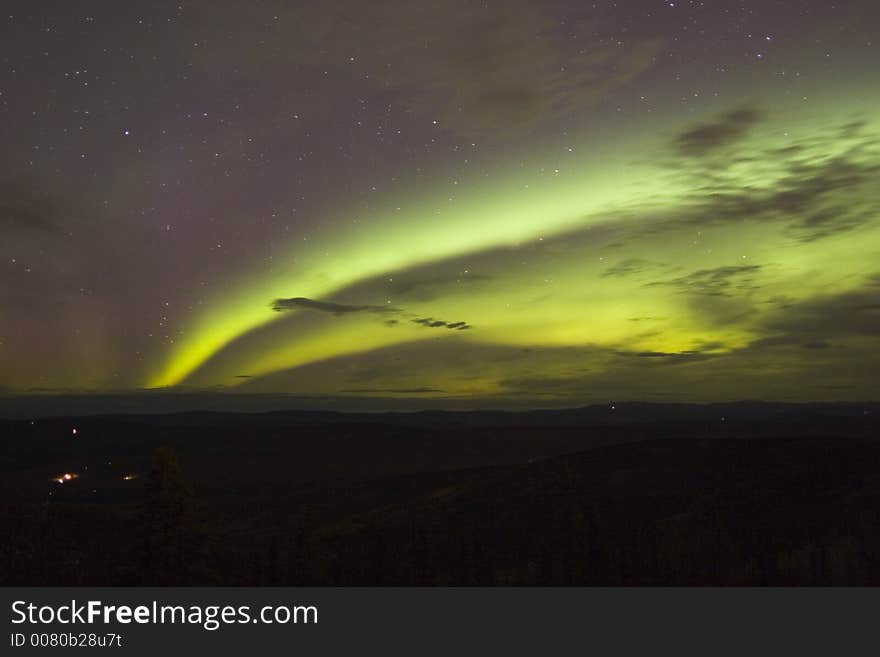 Double arc of Aurora Borealis in cloudy night sky. Double arc of Aurora Borealis in cloudy night sky