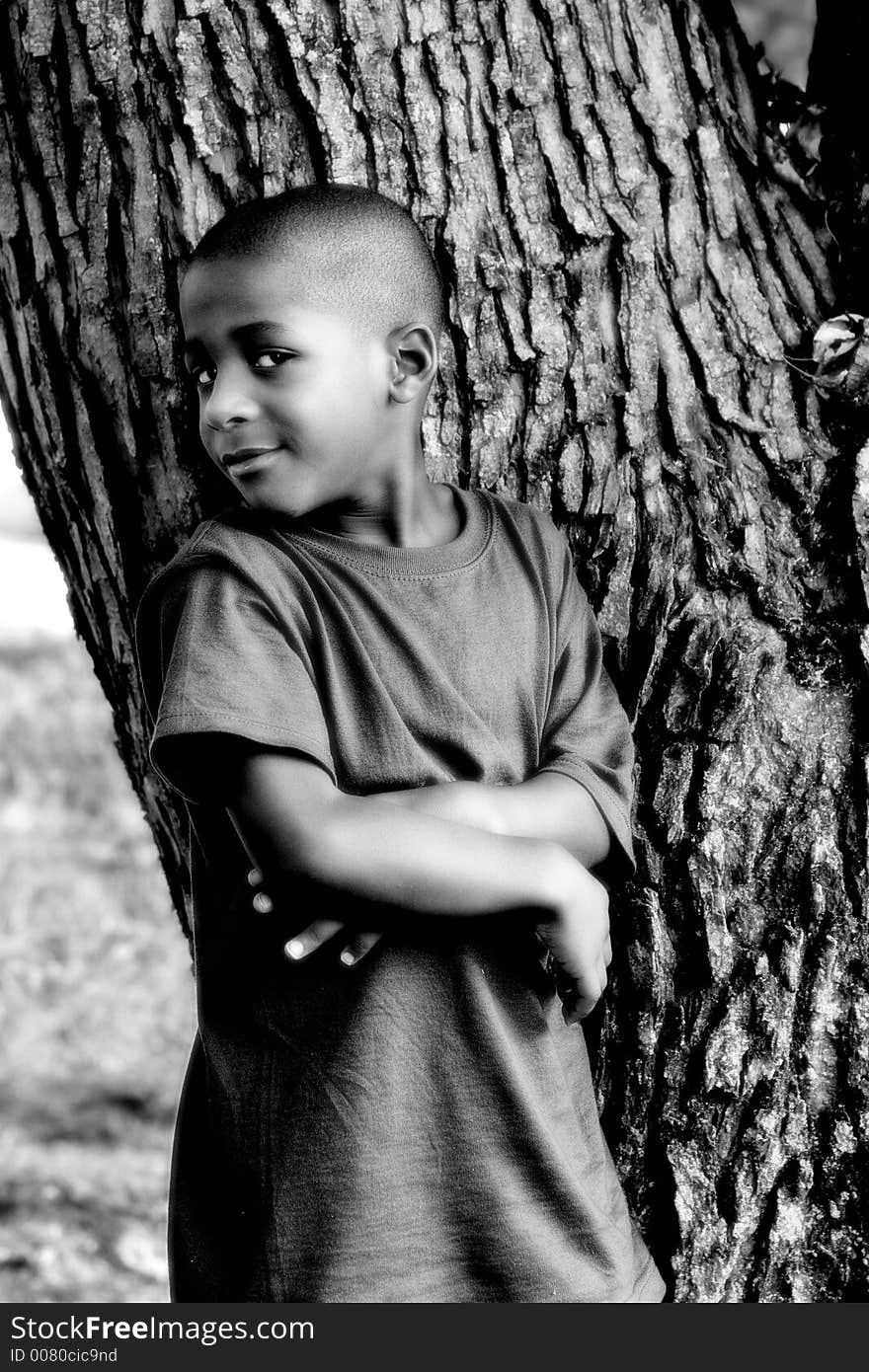 Grandson posing against a tree. Grandson posing against a tree