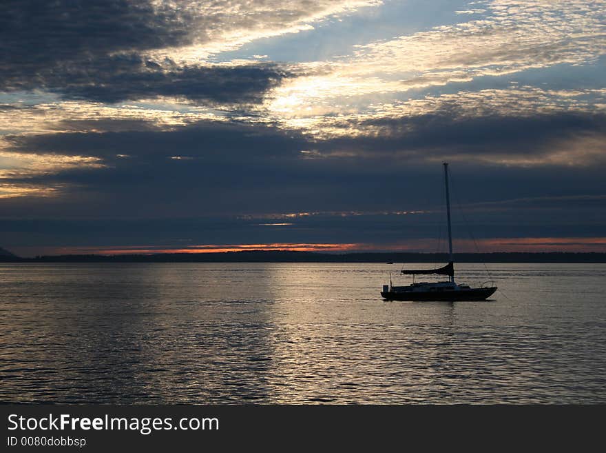 Sillouette of sailboat against sunset in Puget Sound. Sillouette of sailboat against sunset in Puget Sound