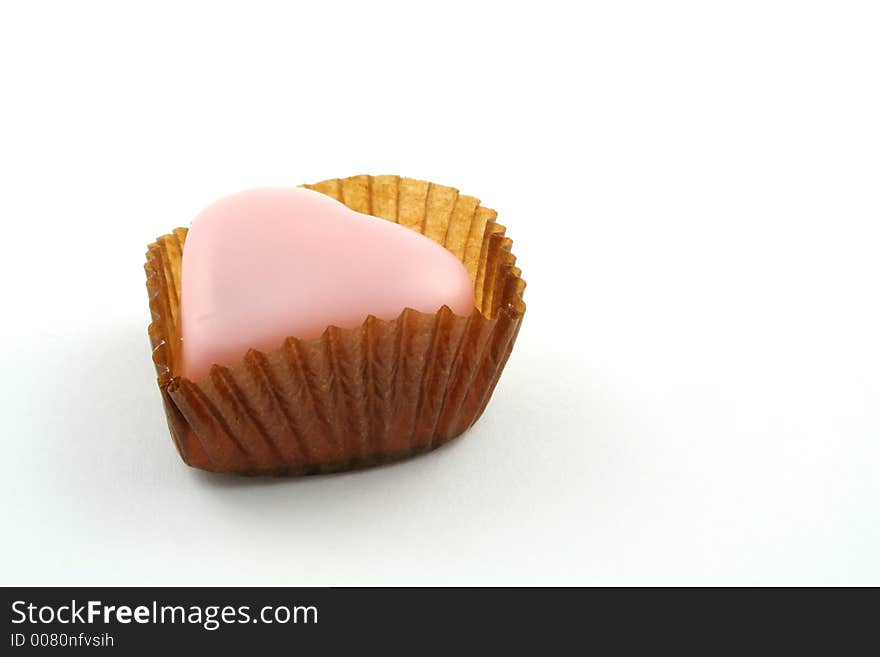 Pink love heart chocolates on a white background