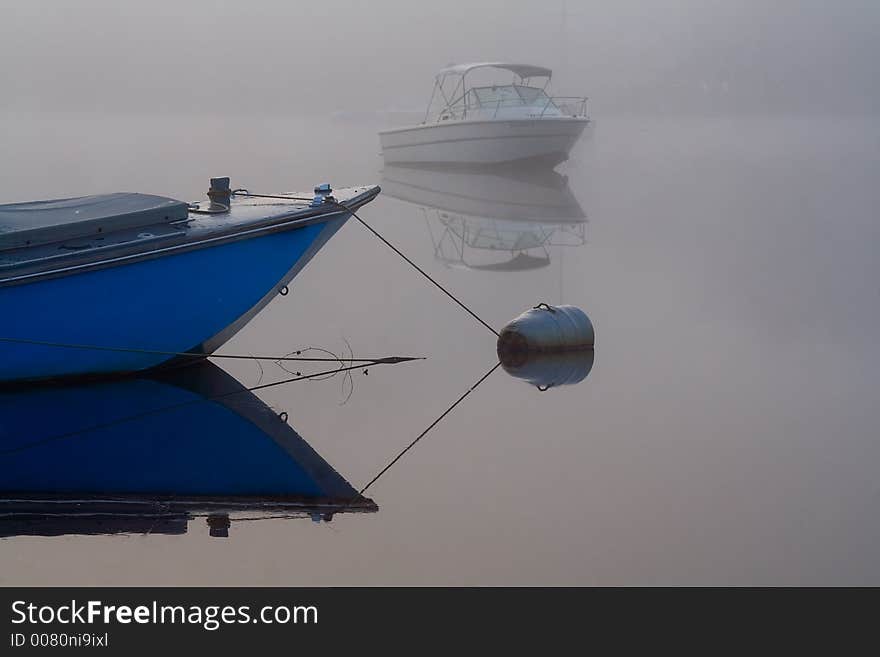 An early morning shot of boats anchored in the Great Egg Harbor River in the fog. An early morning shot of boats anchored in the Great Egg Harbor River in the fog